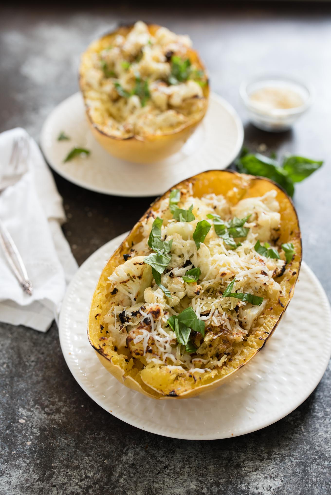 Cheesy Roasted Cauliflower Spaghetti Squash Boats make a great vegetarian meal or side dish, packed with garlicky cauliflower and cheesy goodness.