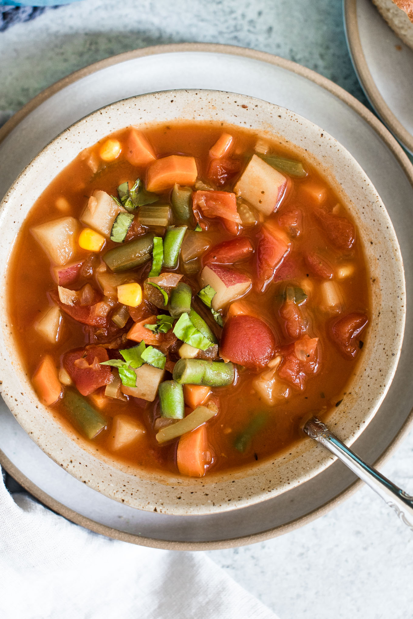 bowl of vegetable soup with spoon in it 