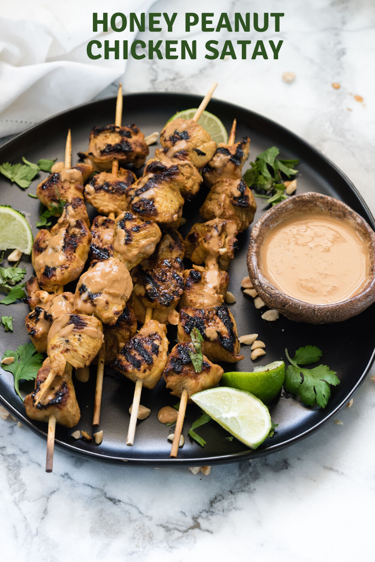 Chicken Satay on a black plate