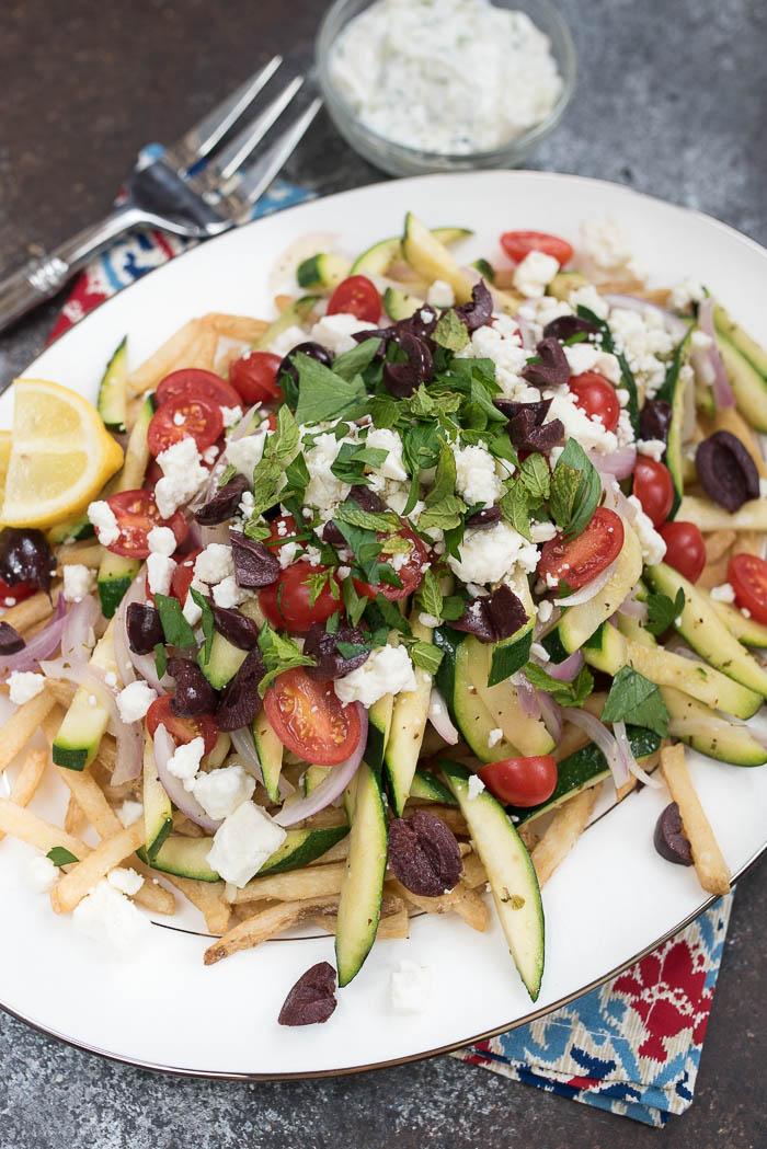 Loaded Mediterranean Fries- Truffle Fries loaded with veggies and Mediterranean flavors like feta, oregano and tzatziki sauce #glutenfree #vegetarian | 