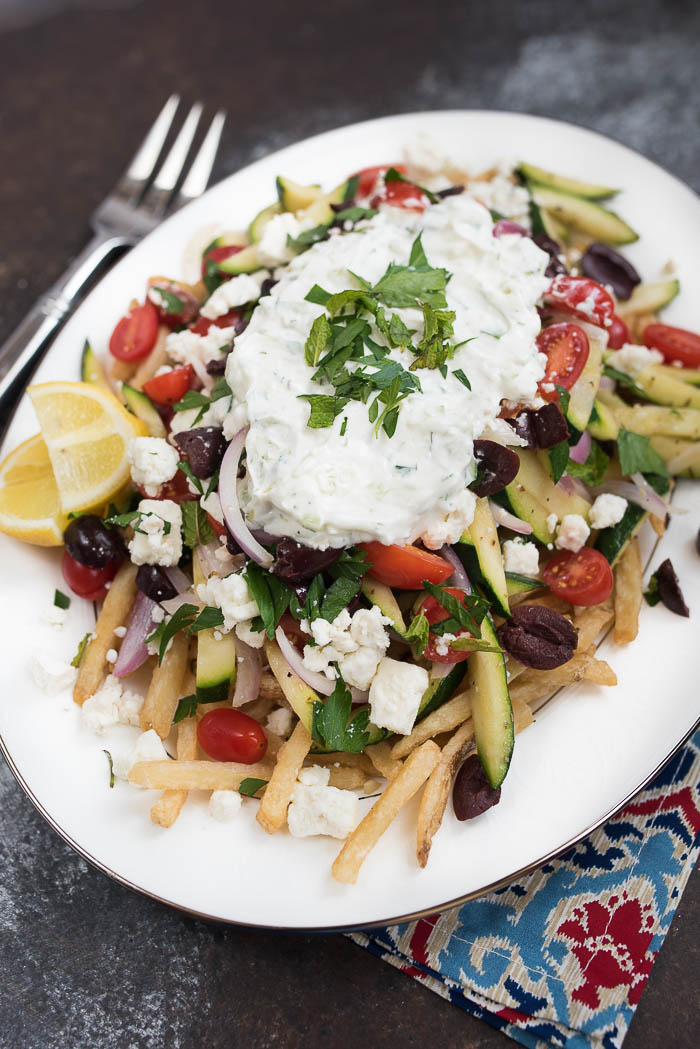 Loaded Mediterranean Fries- Truffle Fries loaded with veggies and Mediterranean flavors like feta, oregano and tzatziki sauce #glutenfree #vegetarian | 