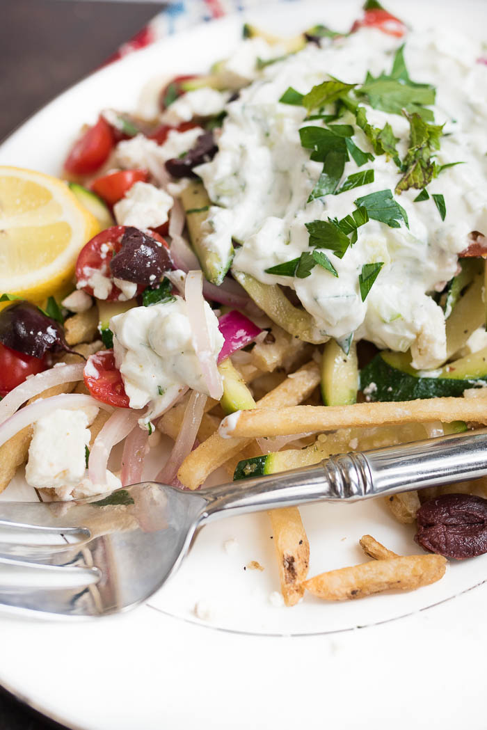 Loaded Mediterranean Fries- Truffle Fries loaded with veggies and Mediterranean flavors like feta, oregano and tzatziki sauce #glutenfree #vegetarian | 