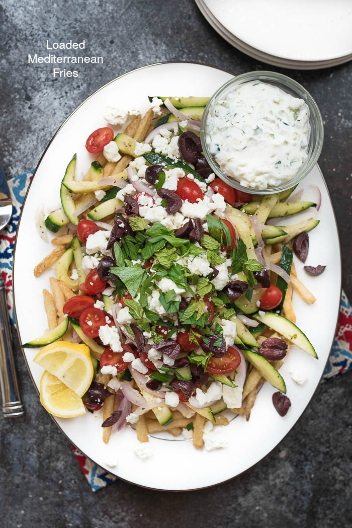 Loaded Mediterranean Fries- Truffle Fries loaded with veggies and Mediterranean flavors like feta, oregano and tzatziki sauce #glutenfree #vegetarian | 