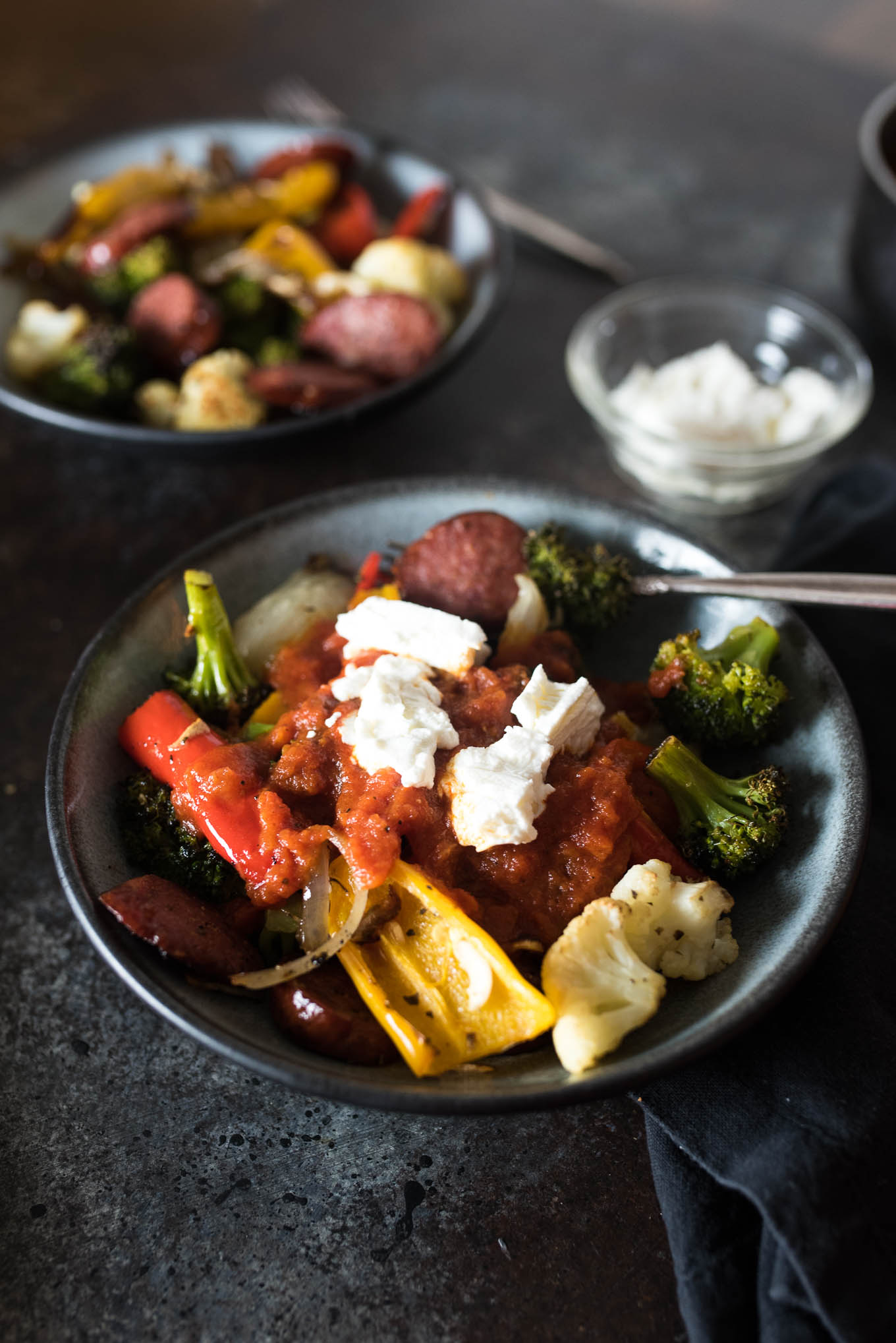 One Pan Roasted Sausage and Vegetables with Marinara and Goat Cheese is low calorie, gluten free and the answer to your dinner dilemma since it only takes a few minutes to prepare and the frees up time while it bakes in the oven.