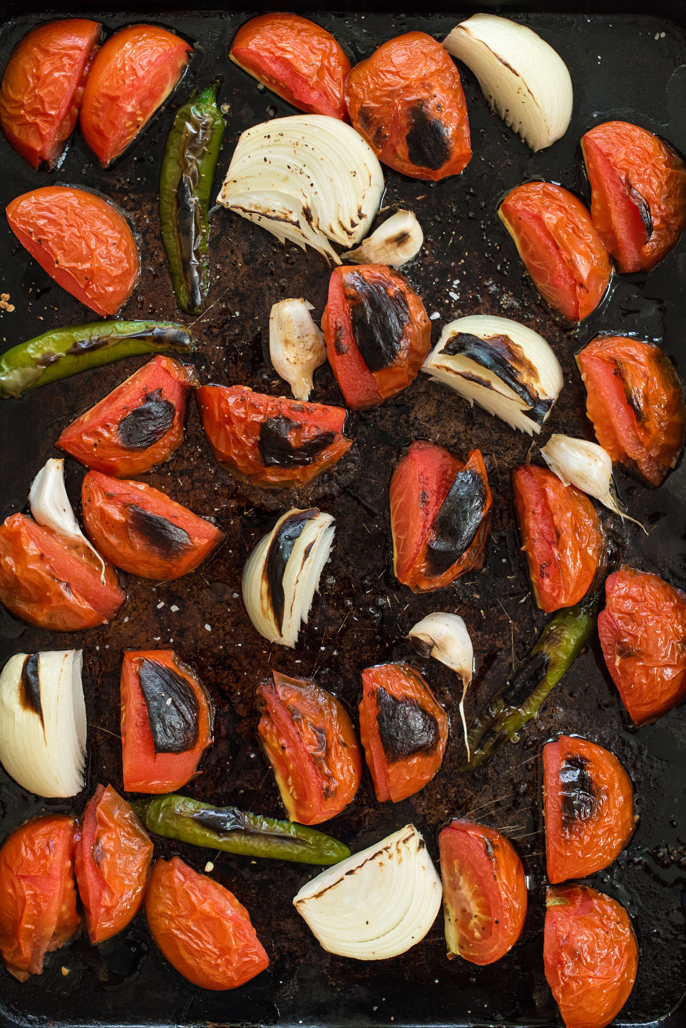 Sheet pan with roasted tomatoes, onions, peppers